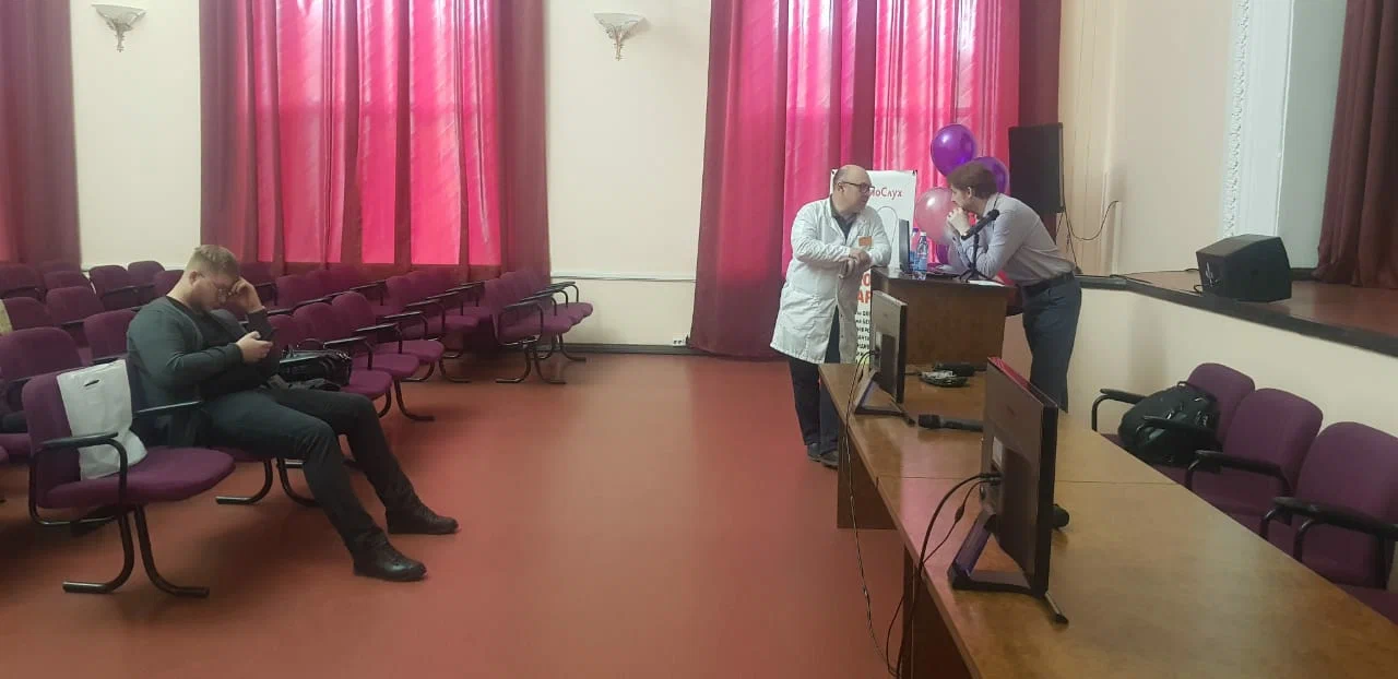 Faculty members speaking during an academic meeting